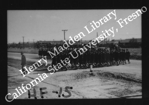 Nurses Marching; Male Officer at Left Leading