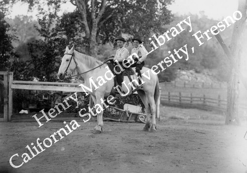 Two young boys on horseback