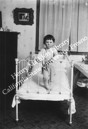 Toddler standing in crib