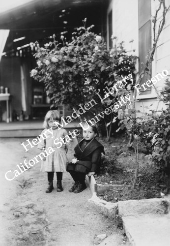 Two young children with the roses