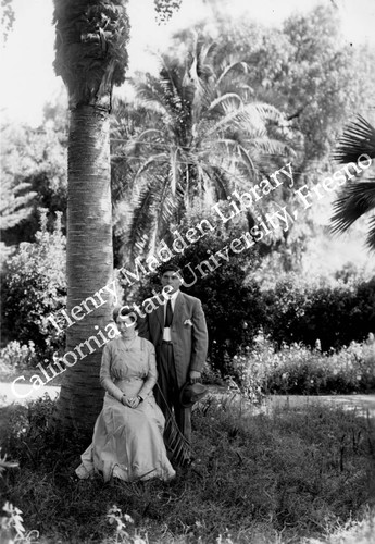 Young couple next to palm tree