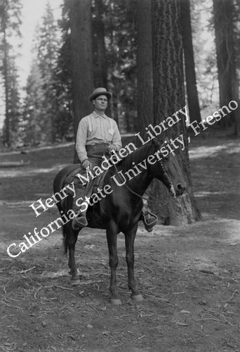 Man with hat on horse