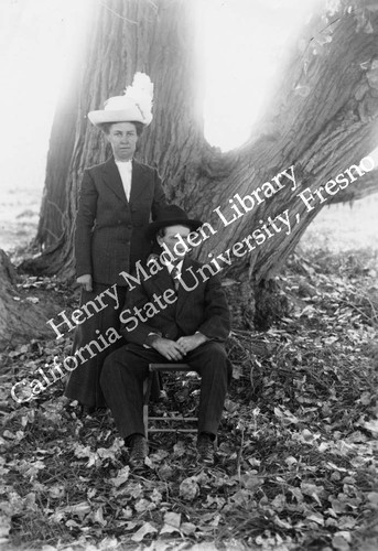 Man and woman in front of cottonwood tree