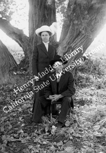 Man and woman in front of cottonwood tree