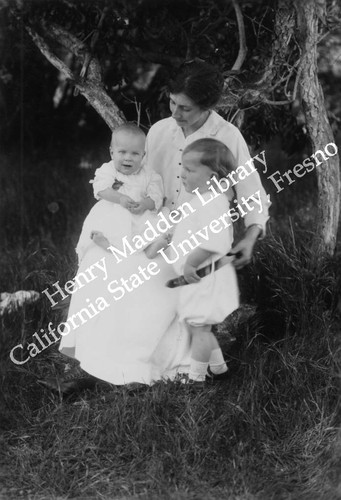 Mother with children in the grass