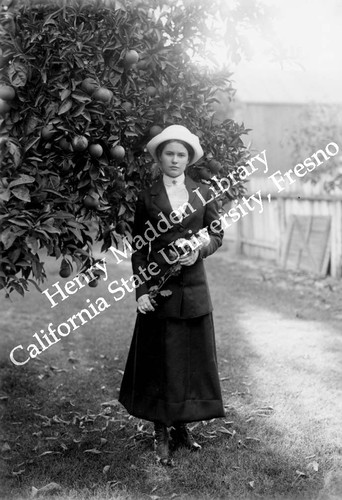 Woman next to citrus tree