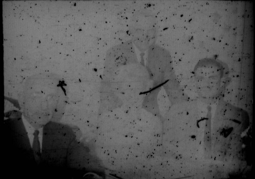 Leon Peters seated at a table with an unidentified woman and two unidentified men