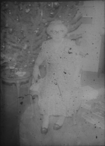 Unidentified woman (Peters relative?) seated in front of Christmas tree