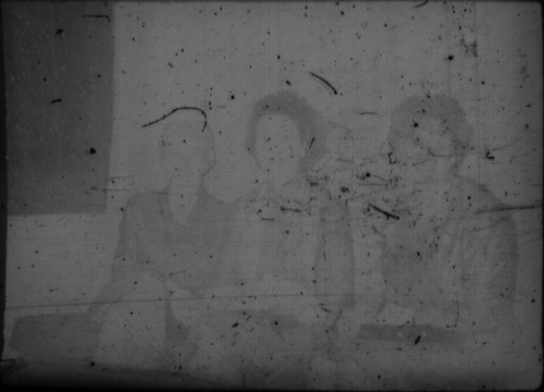Three unidentified women sitting on couch