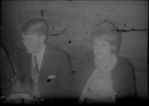 Unidentified young man and woman seated at a table