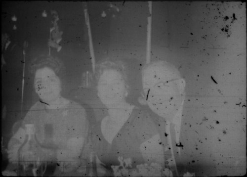 Alice Peters with unidentified man and woman in restaurant