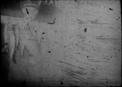 Unidentified man (Peters relative?) standing next to stringer of fish