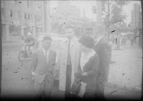 Doctor and others standing on street corner