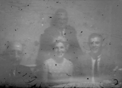 Leon Peters seated at a table with an unidentified woman and two unidentified men