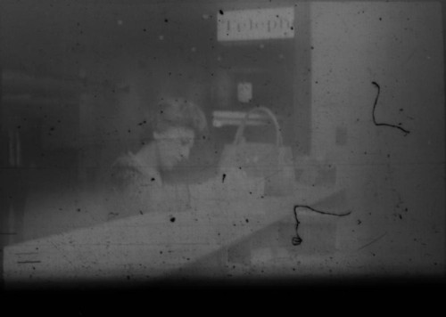Unidentified woman standing at desk in airport