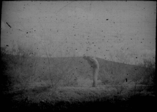 Unidentified man looking into ditch