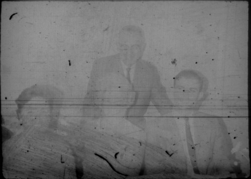 Alice Peters seated at a table with an unidentified woman and two unidentified men
