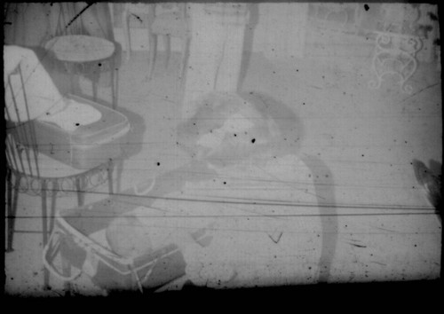 Unidentified woman with infant in crib (Peters relatives?)