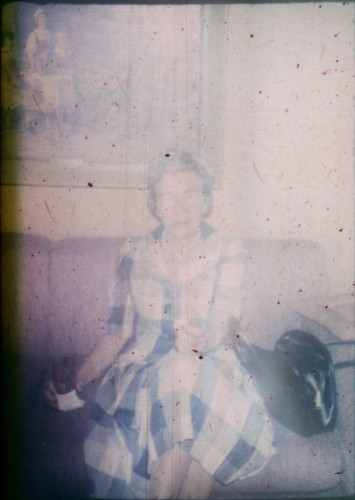 Unidentified woman seated on a couch