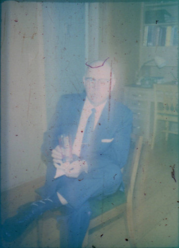 Unidentified man seated in a chair