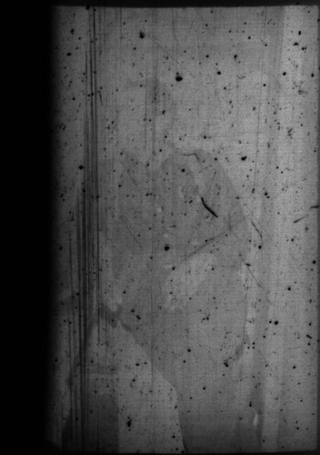 Unidentified man sitting in cabin at Myrtle Lake