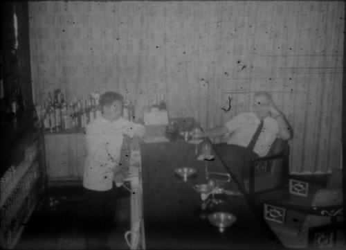 Unidentified man and bartender in bar