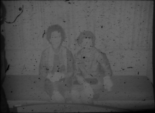 Alice Peters and unidentified woman sitting on couch