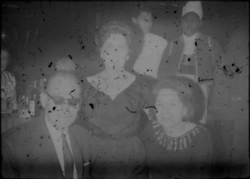 Alice Peters with unidentified man and woman in restaurant