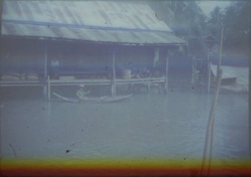 Unidentified person paddling canoe