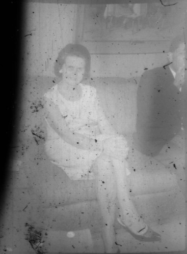 Unidentified woman and man seated on a couch