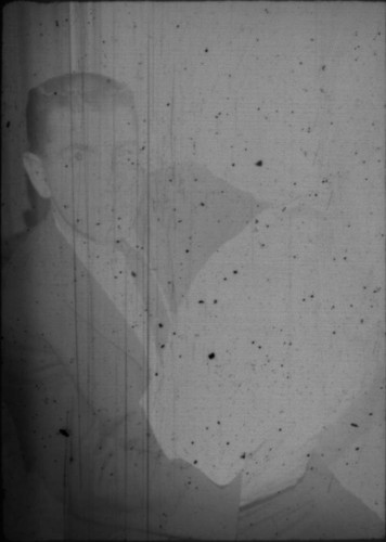 Unidentified man and infant seated on a couch (Peters relatives?)