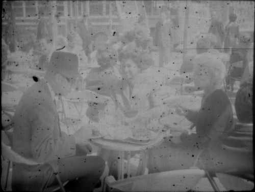 Alice Peters with unidentified man and woman at a cafe