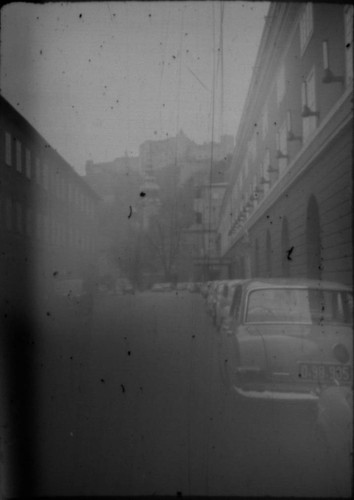View of street with castle in background in unidentified city