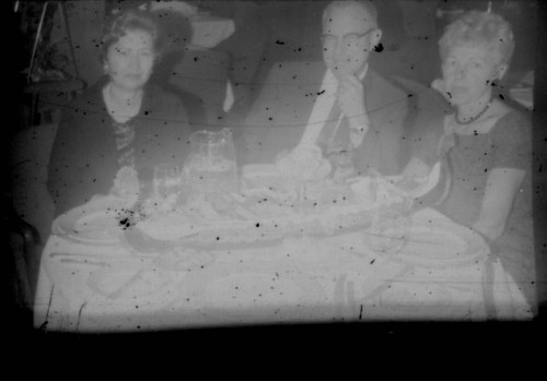 Alice Peters with unidentified man and woman at a table