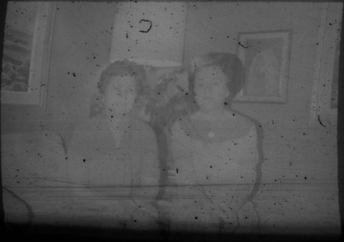 Alice Peters and unidentified woman seated on a couch