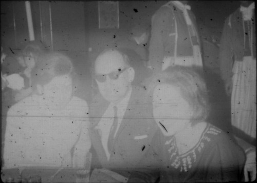 Two unidentified women and man seated in a restaurant