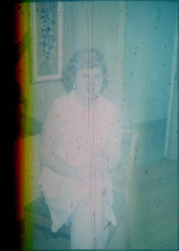 Unidentified woman sitting in a chair