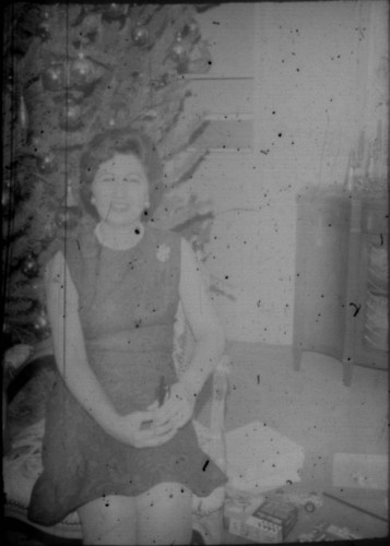 Alice Peters seated in front of a Christmas tree