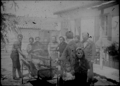 Unidentified group of people gathered around a grill