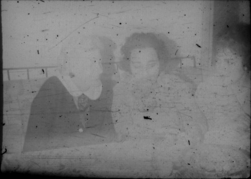 Three unidentified women sitting on a couch