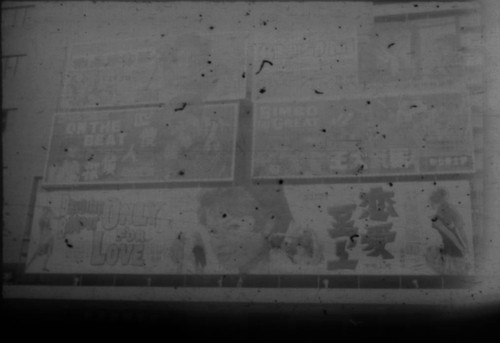 Movie posters in unidentified city