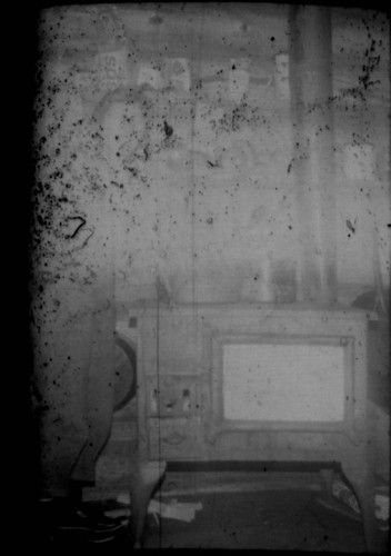 Alice Peters? standing next to a wood stove