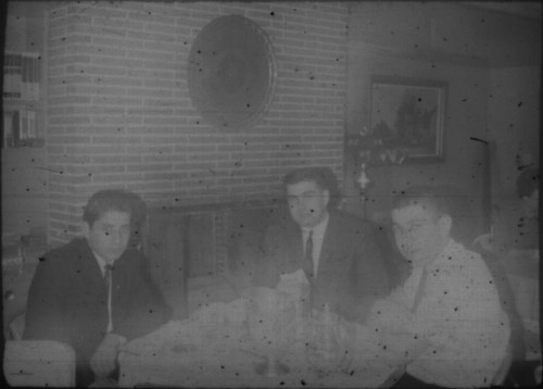 Three unidentified men seated at a table (Peters relatives?)
