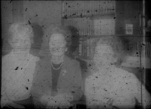 Alice Peters and two unidentified women standing in front of a bookcase