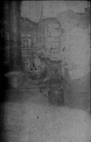 Unidentified woman (Peters relative?) standing next to a wood stove