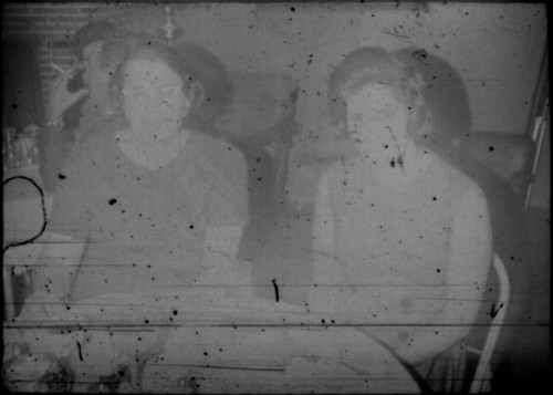 Two unidentified women seated at a table (Peters relatives?)