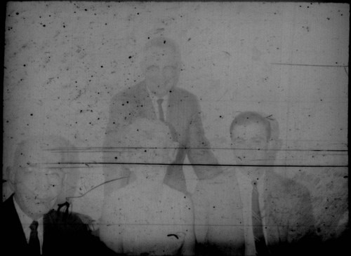 Leon Peters seated at a table with an unidentified woman and two unidentified men