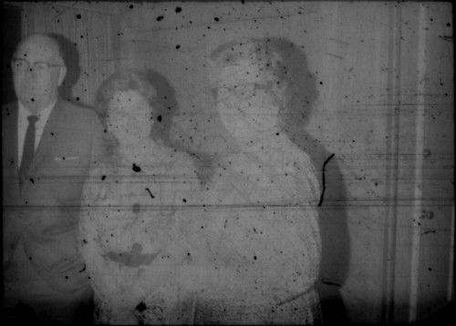 Alice Peters standing with unidentified man and woman (Peters relatives?)