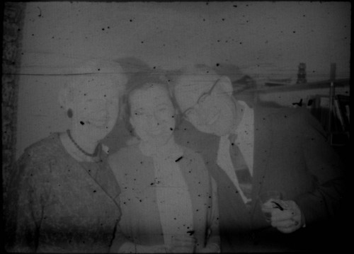 Two unidentified women with unidentified man