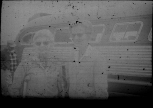 Two unidentified women (Peters relatives?) standing in front of a bus